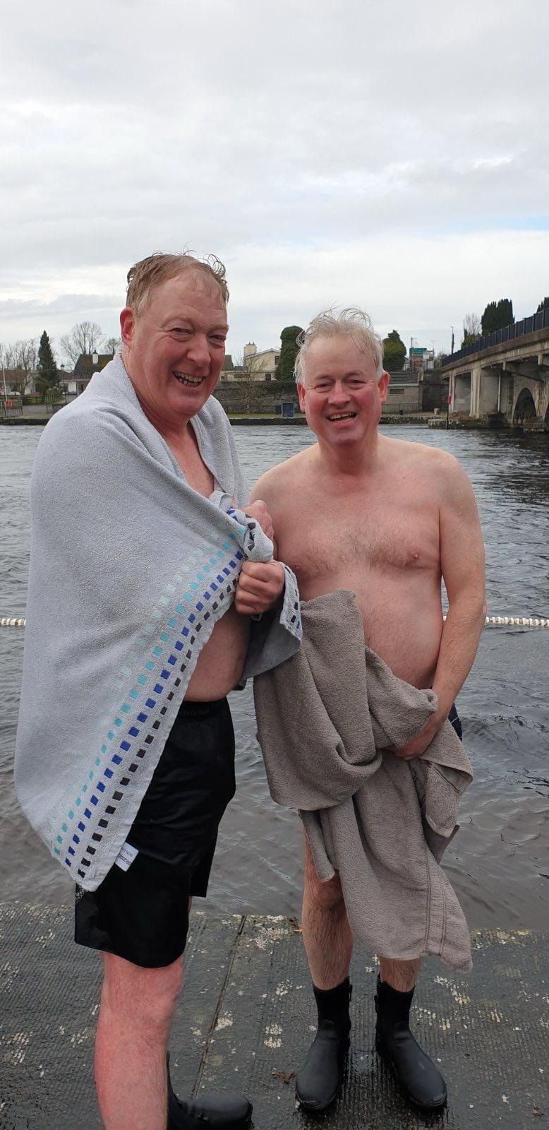 Two club members after a swim by the water