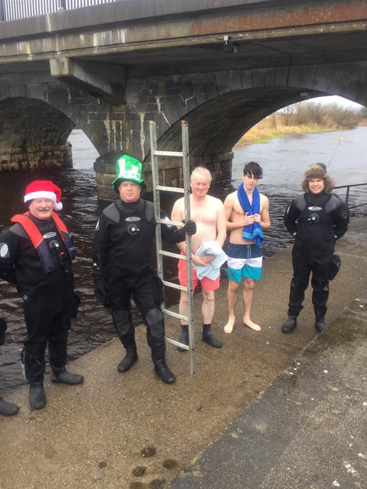 Club members gathered beneath the bridge after a swim
