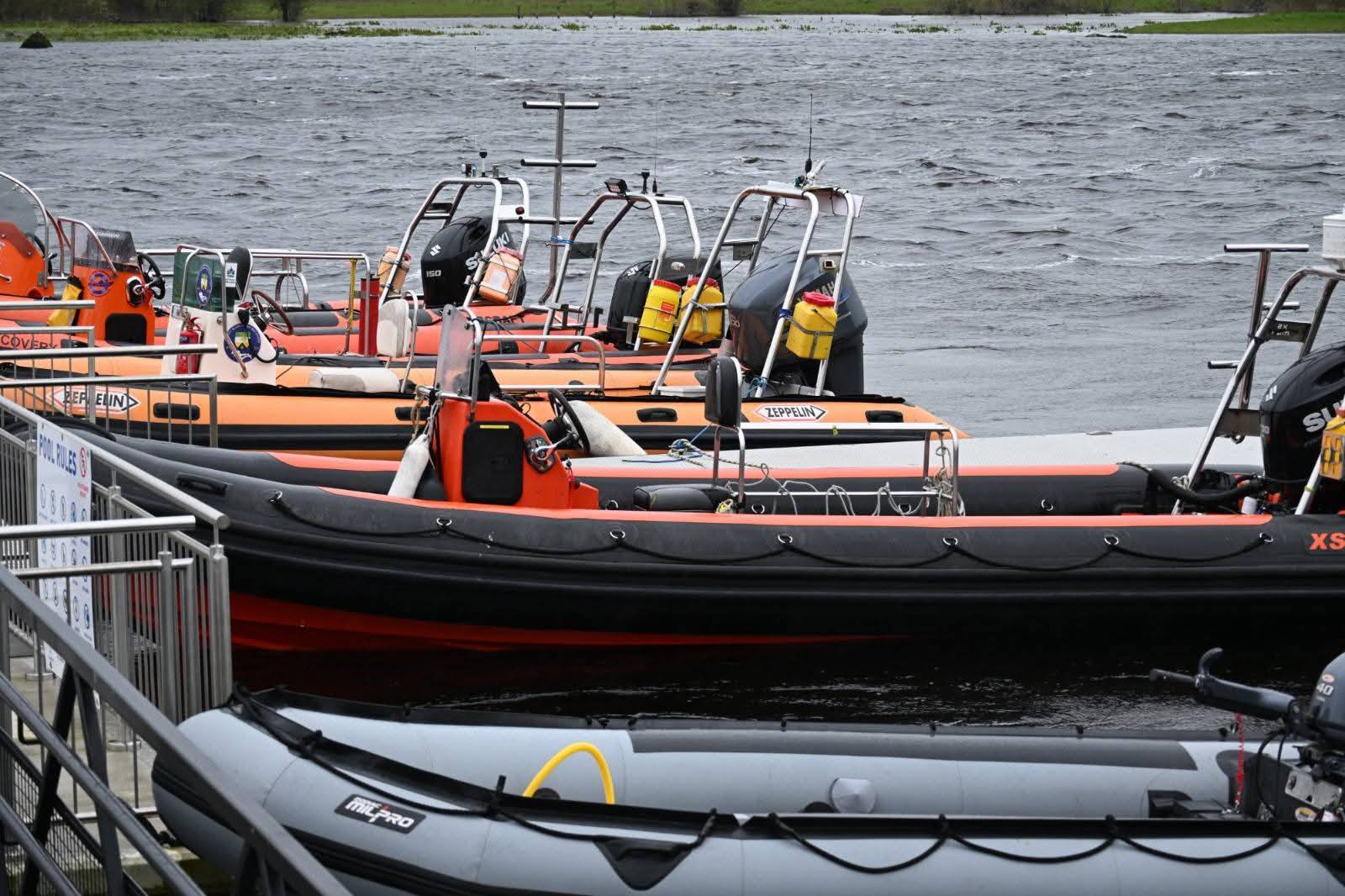 Several club boats lined up at the dock