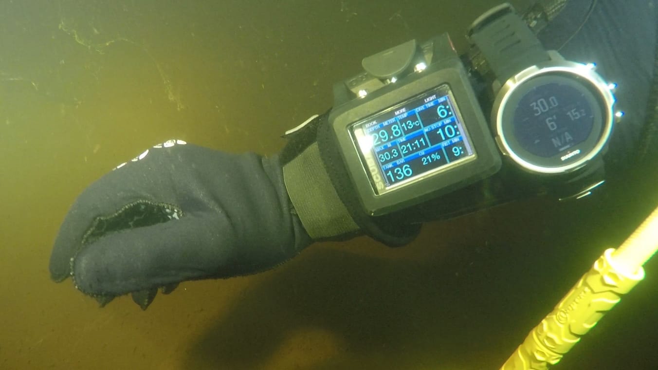 Dive computer and torch underwater during a dive